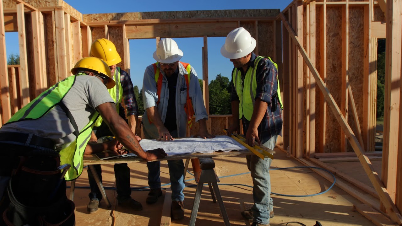 four builders reviewing building plans   Stock Video Footage   Artgrid